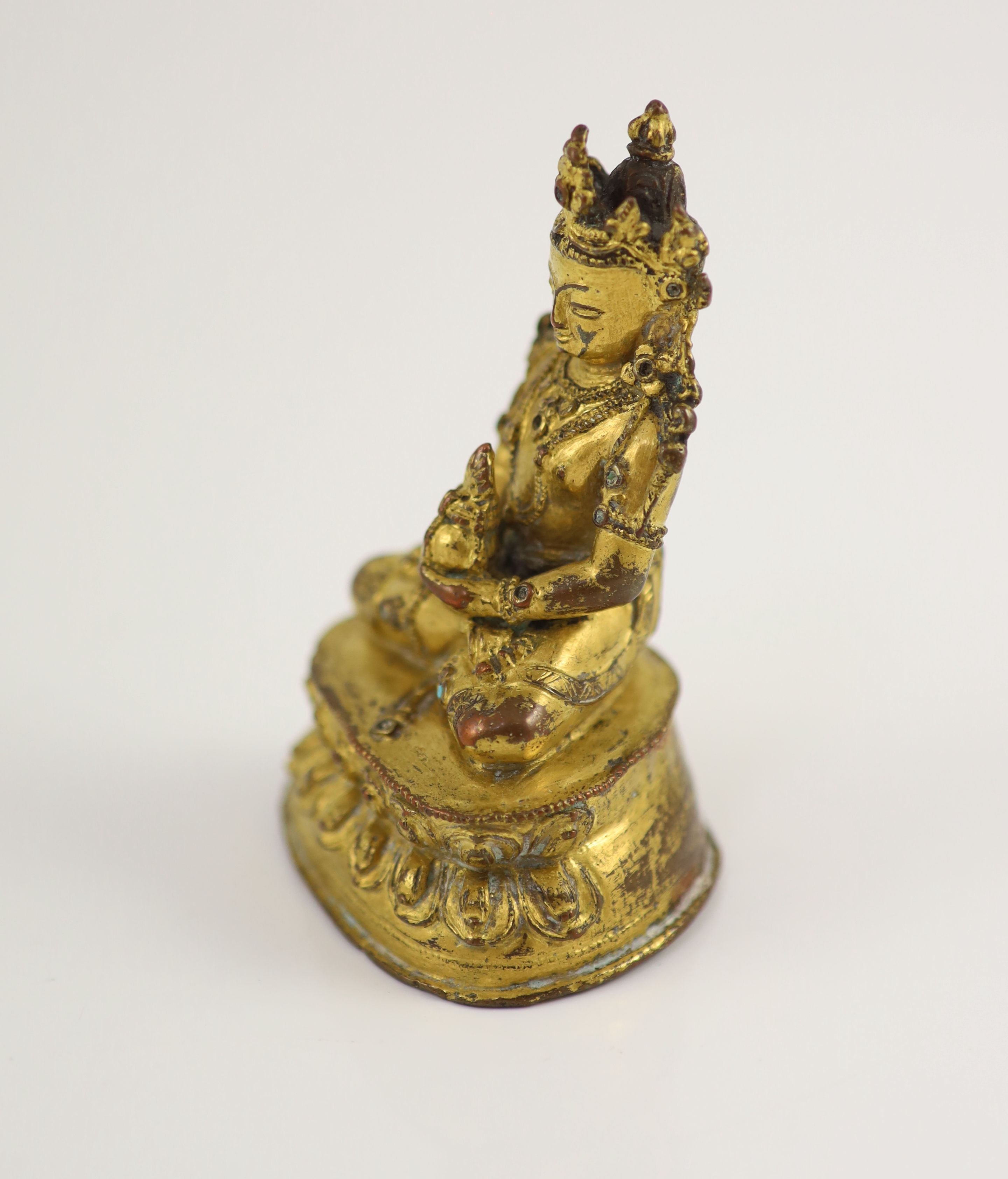 A Tibetan gilt copper alloy seated figure of Amitayus, possibly 15th/16th century, 9cm high